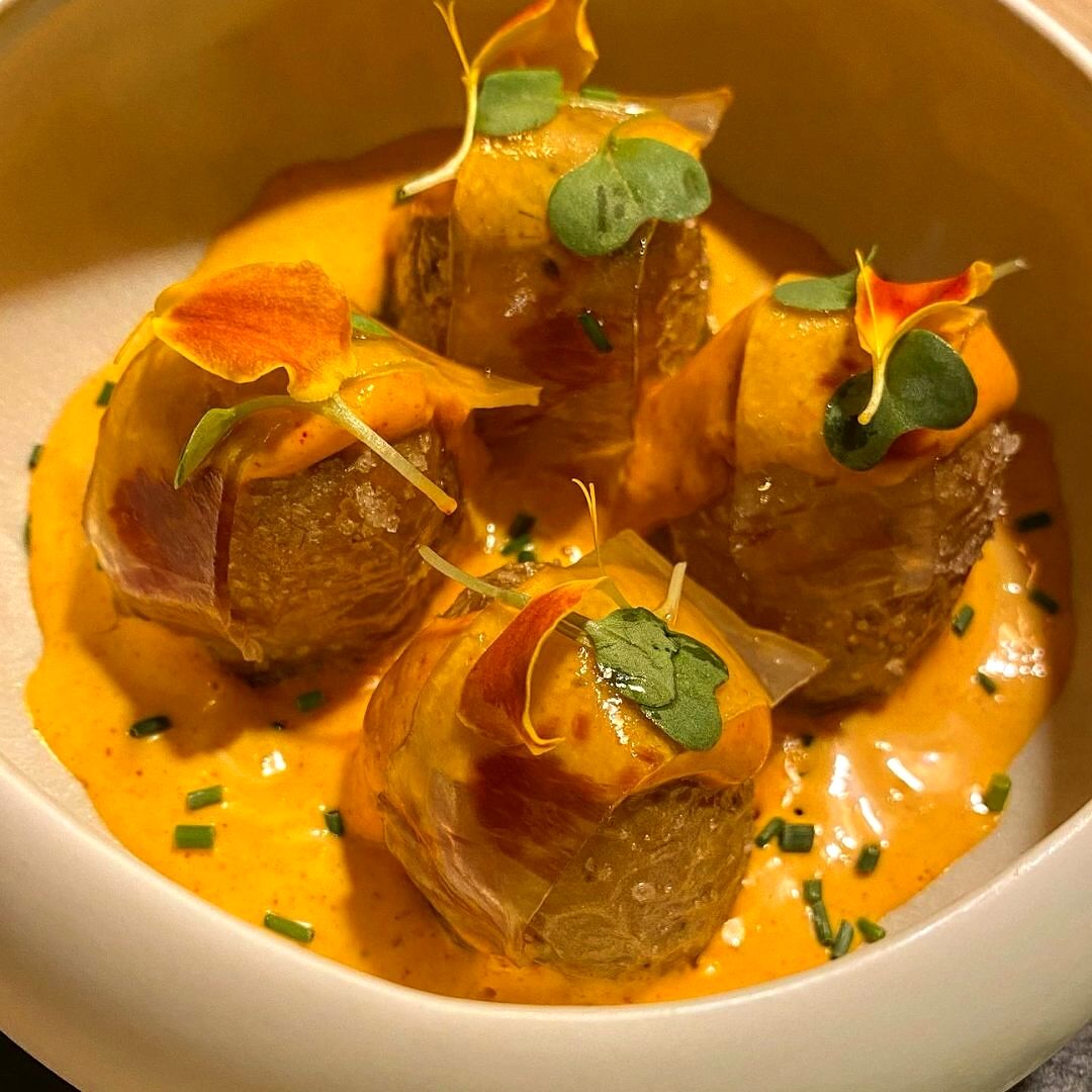 Bravas con salsa maragata y papada ibérica de bellota, plato premiado de la casa